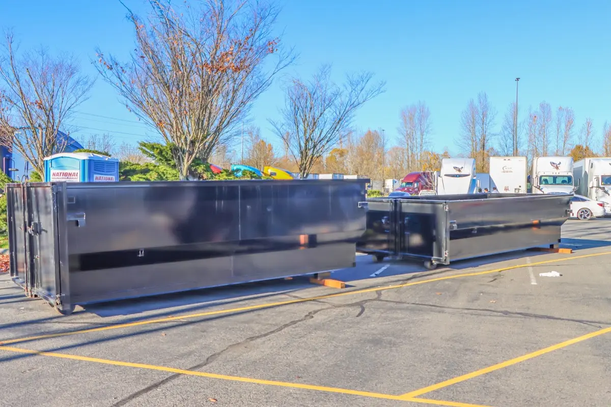Professional dumpster rental service with roll-off container on residential driveway in Brecknock